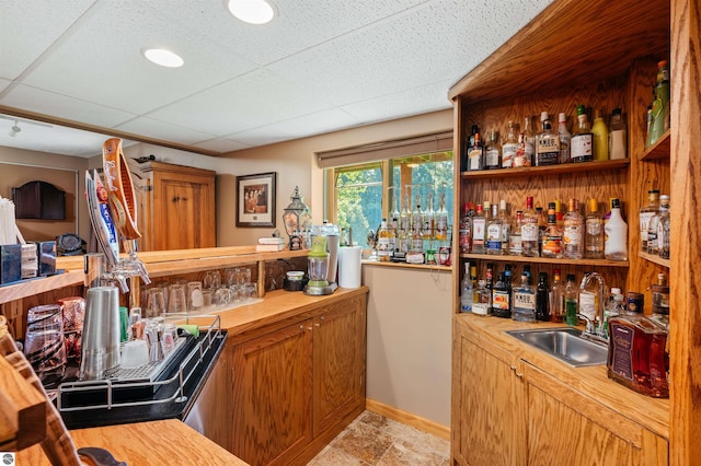 bar featuring wood counters and sink