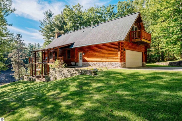 view of front of property featuring a garage and a front lawn