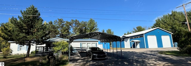 view of front of home featuring a carport, an outbuilding, and a garage