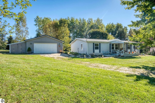 view of front of home featuring a front yard, an outdoor structure, a garage, and a porch