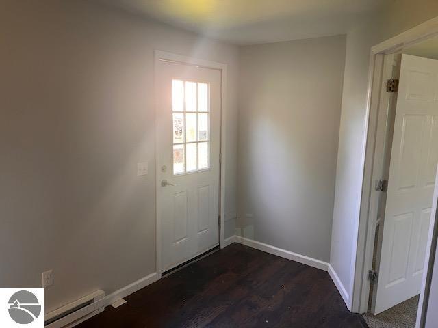 entryway with a baseboard radiator and dark hardwood / wood-style flooring