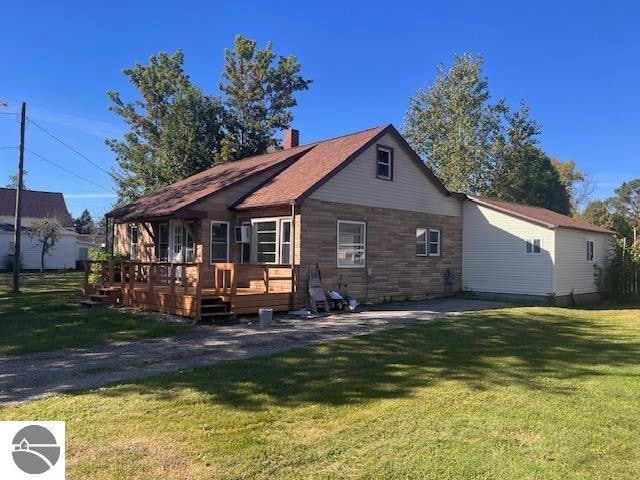 back of house featuring a yard and a deck