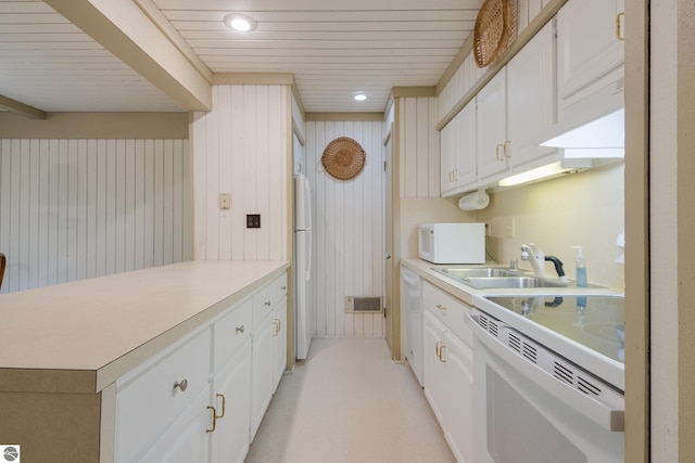 2500 Josef Strasse Unit 410-411, Bellaire, MI 49615 - kitchen with white appliances, a peninsula, white cabinets, light countertops, and a sink