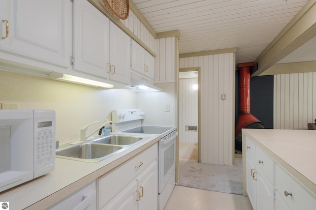 2500 Josef Strasse Unit 410-411, Bellaire, MI 49615 - kitchen featuring white appliances, white cabinetry, under cabinet range hood, light countertops, and a sink
