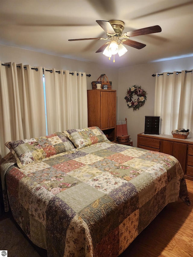 bedroom with ceiling fan and wood-type flooring