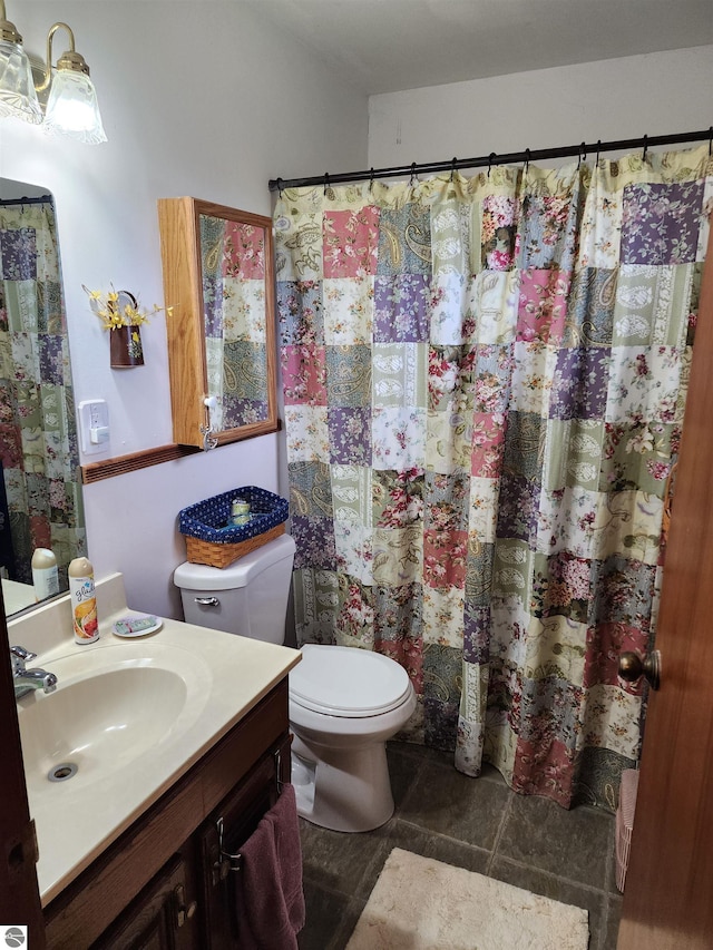 bathroom with toilet and vanity