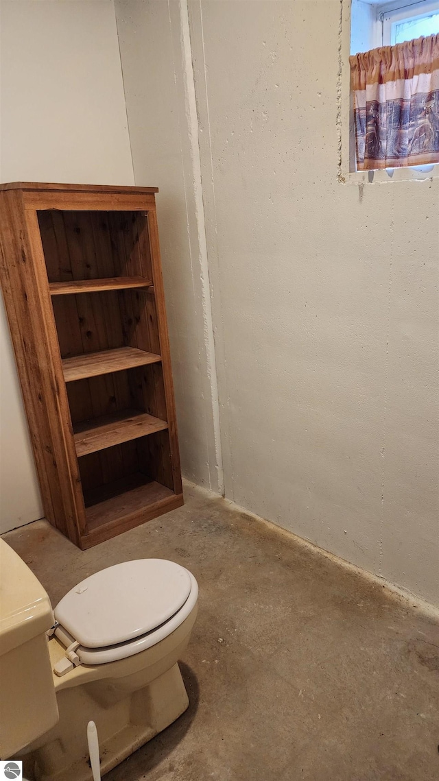 bathroom featuring toilet and concrete floors