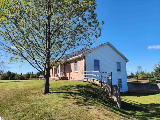 view of side of home with a yard