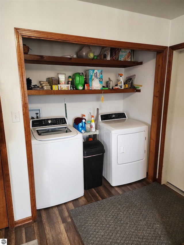 clothes washing area with dark wood-type flooring and washing machine and clothes dryer