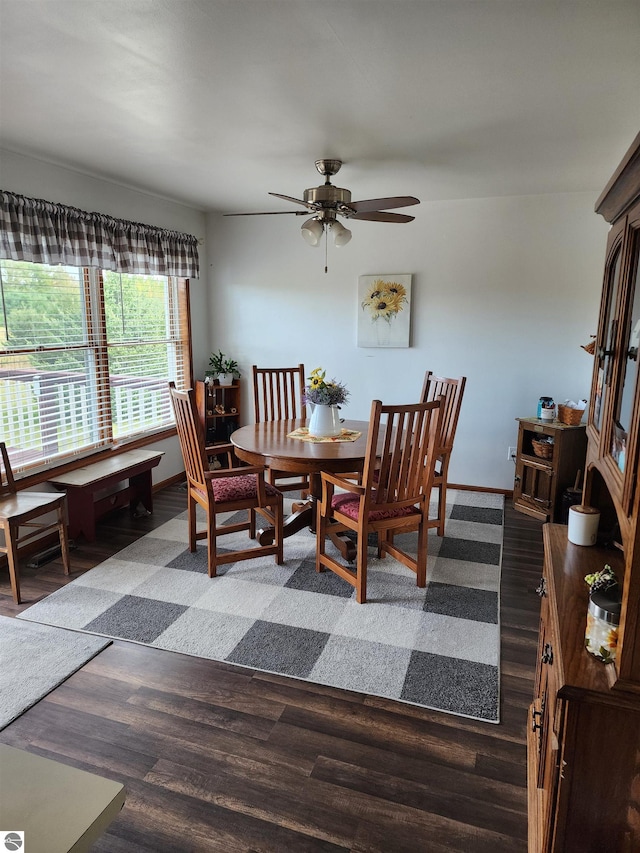 dining space with ceiling fan and dark hardwood / wood-style floors