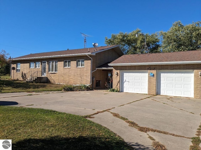 ranch-style home with a garage and a front yard