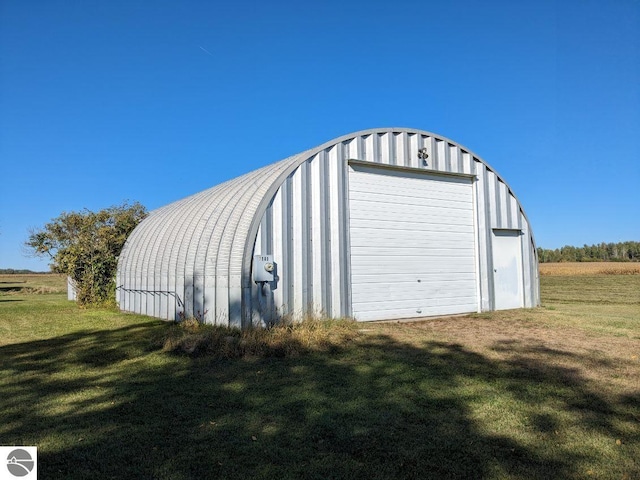 view of outbuilding featuring a yard and a garage