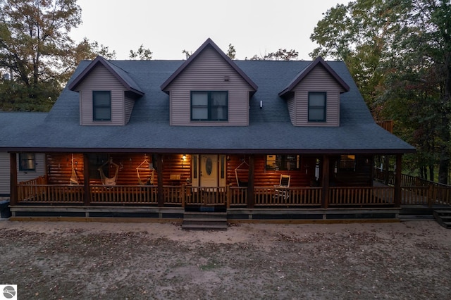 log-style house with covered porch