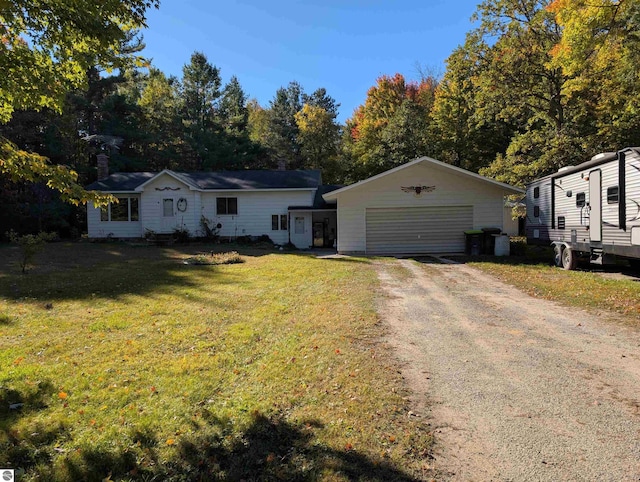 view of front of home with an outbuilding, a garage, and a front yard