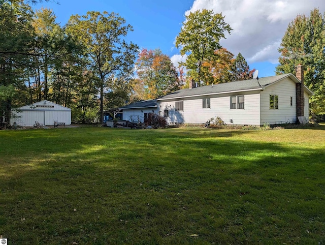 rear view of property featuring a yard