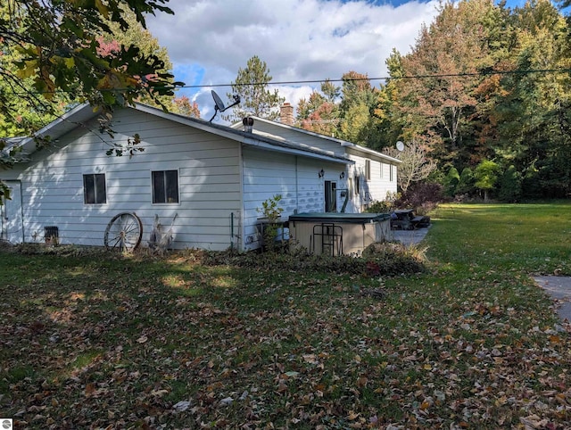 view of side of home with a lawn