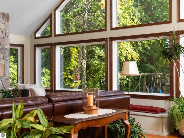 sunroom featuring lofted ceiling