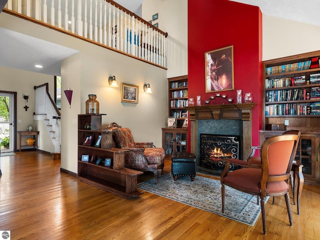 living room featuring hardwood / wood-style flooring and high vaulted ceiling