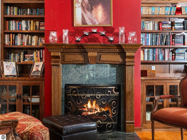 sitting room featuring a premium fireplace and hardwood / wood-style floors