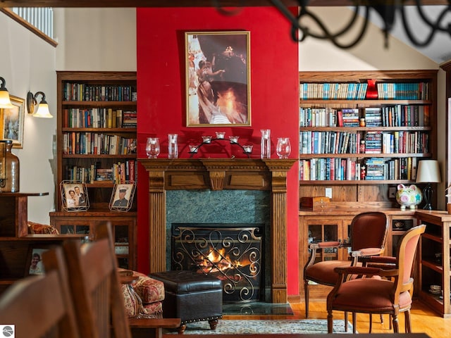 living area with wood-type flooring and a premium fireplace