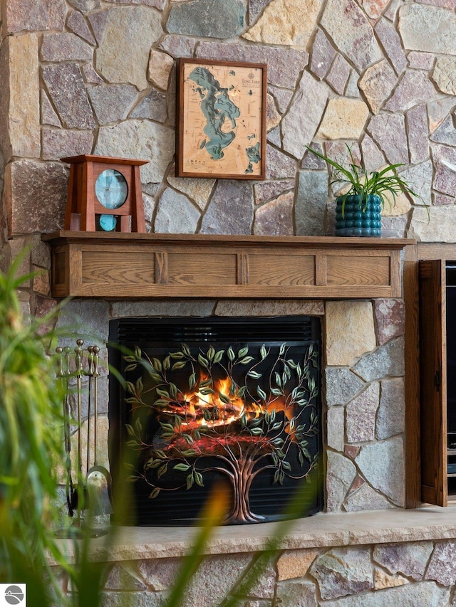 interior details with a stone fireplace