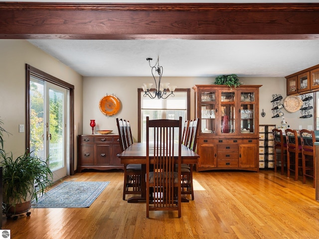 dining area featuring light hardwood / wood-style floors and a notable chandelier