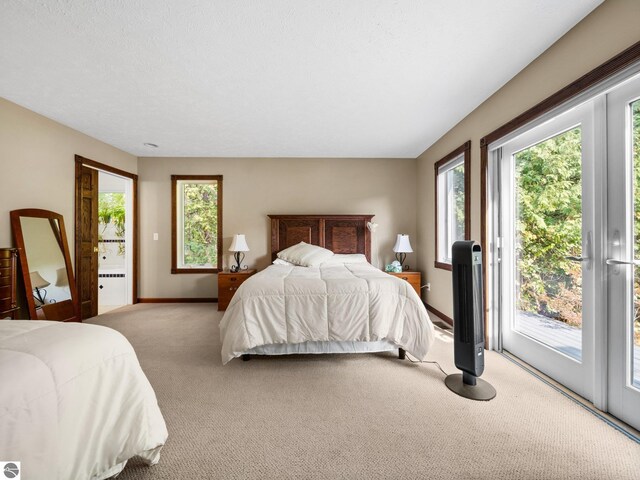 carpeted bedroom featuring access to exterior and a textured ceiling