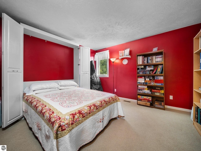 bedroom featuring carpet floors and a textured ceiling