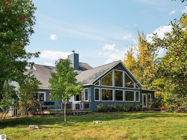 rear view of property with a yard