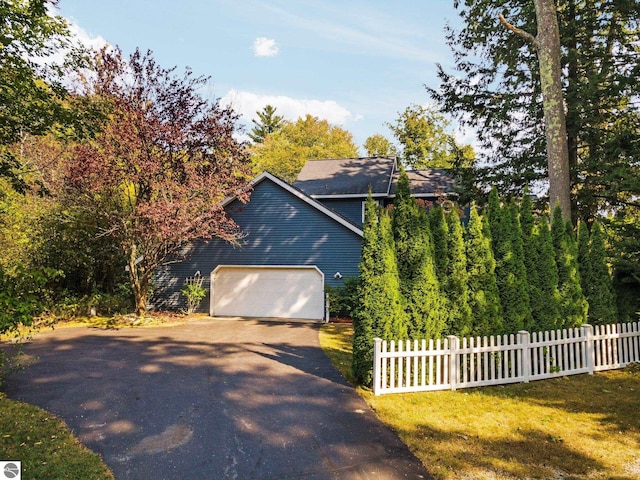 view of property exterior with a yard and a garage