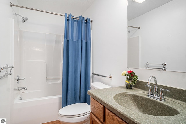 full bathroom with vanity, shower / tub combo, toilet, and a textured ceiling