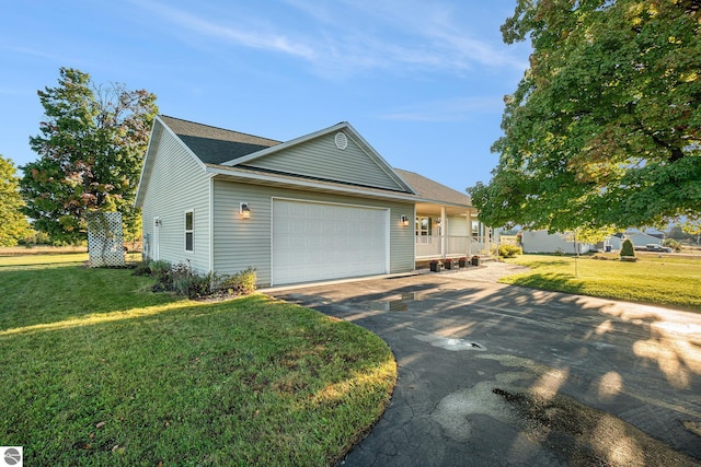 view of front of property with a front yard and a garage