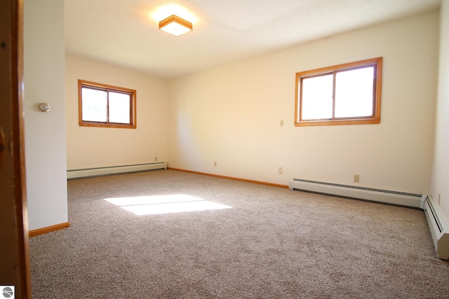 carpeted spare room with a baseboard radiator