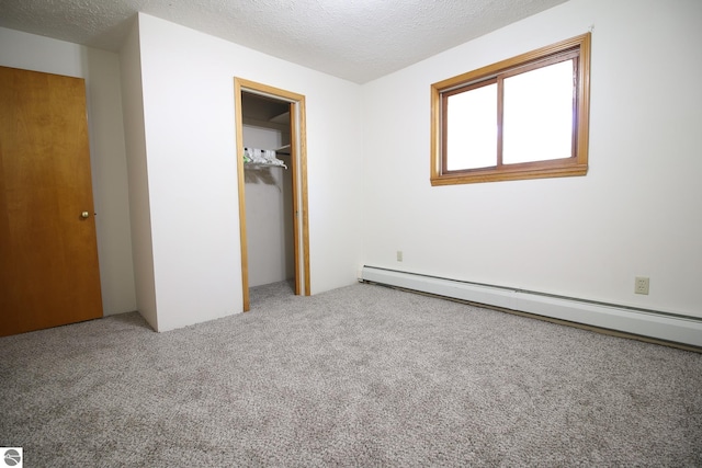 unfurnished bedroom featuring a closet, carpet flooring, a textured ceiling, and a baseboard radiator