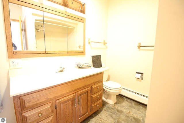 bathroom with vanity, baseboard heating, and toilet