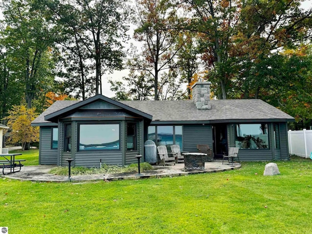 rear view of house featuring a patio and a lawn