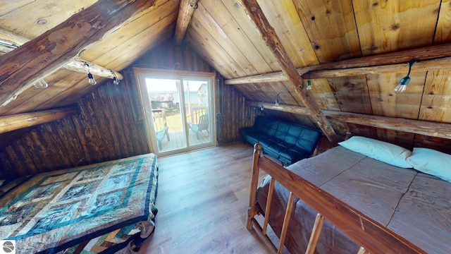 bedroom with vaulted ceiling with beams, access to exterior, light hardwood / wood-style floors, and wooden ceiling