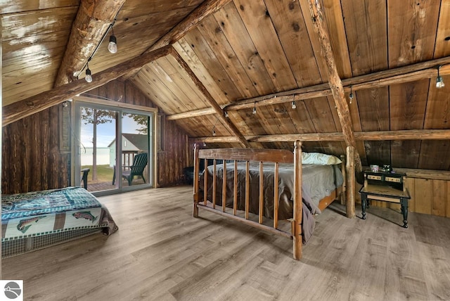 bedroom featuring wooden walls, vaulted ceiling with beams, light hardwood / wood-style floors, and wood ceiling