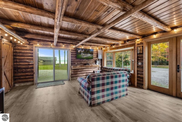 interior space featuring french doors, a barn door, beamed ceiling, and wooden ceiling