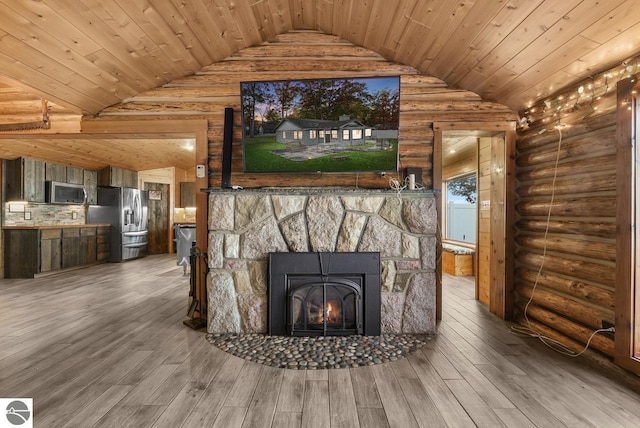 interior details with a fireplace, wood ceiling, stainless steel appliances, log walls, and hardwood / wood-style flooring