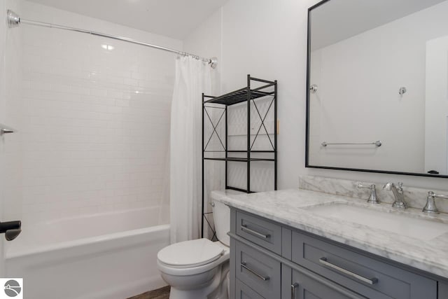 full bathroom featuring vanity, shower / bath combo with shower curtain, and toilet