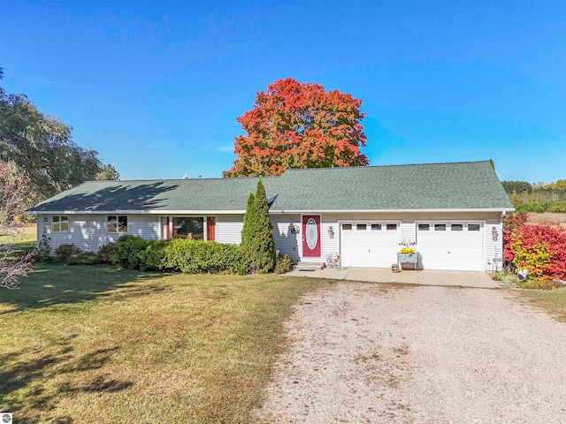 single story home with a garage and a front lawn