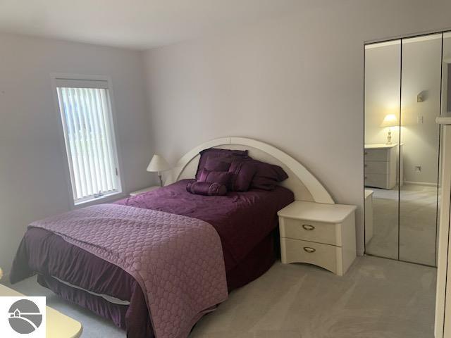 carpeted bedroom featuring a closet