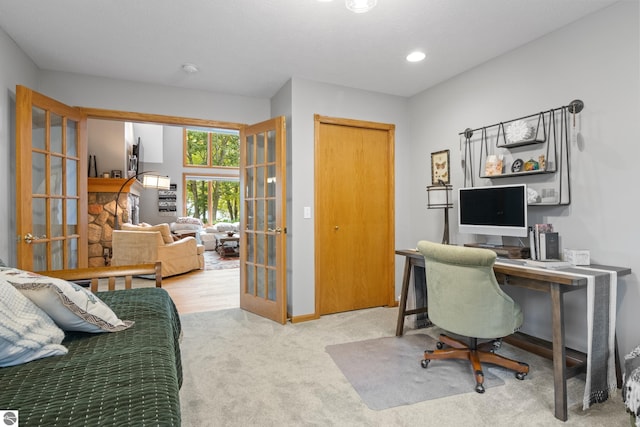 carpeted office featuring french doors