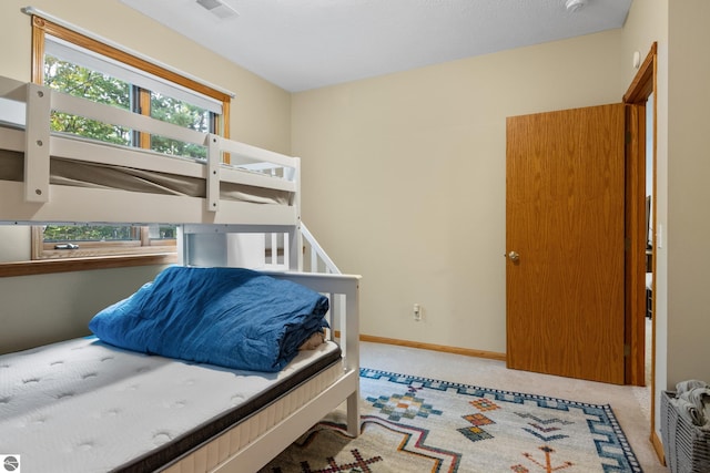 bedroom featuring light carpet