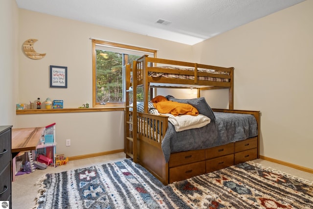 carpeted bedroom featuring a textured ceiling