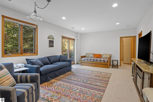 living room featuring light carpet and plenty of natural light