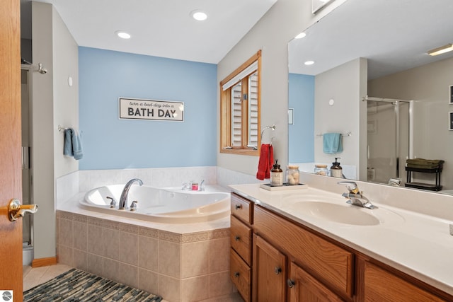 bathroom featuring independent shower and bath, vanity, and tile patterned floors