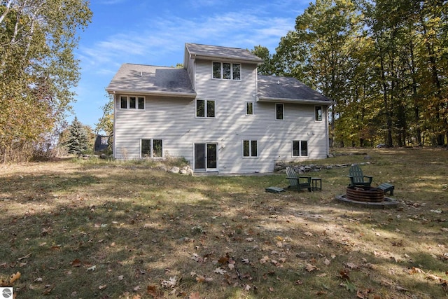 rear view of property with a lawn