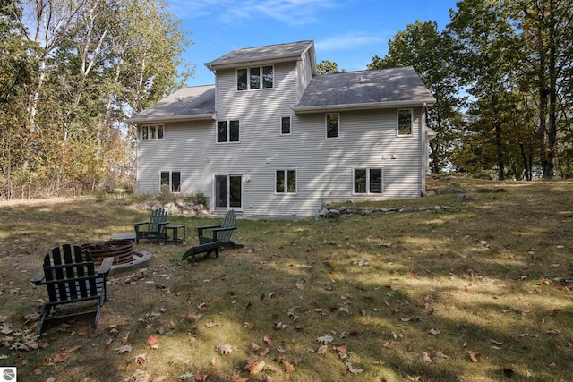 rear view of property with a yard